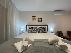 a bedroom with a bed with two towels on it at House Jesenova in Selce