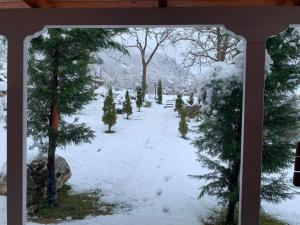 a view of a garden in the snow at Bujtina Shpella e Plakës Çerçan Librazhd in Librazhd +25 photos