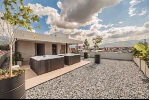 a house with a hot tub on the roof at Laureles Studios - Tomas in Medellín