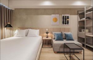 a hotel room with two beds and a couch at Laureles Studios - Tomas in Medellín +98 photos