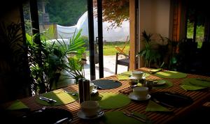 a wooden table with green napkins and plates on it at The Lodge Rooms in Coleford