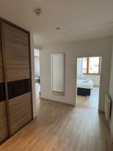 an empty room with a sliding door and a bedroom at Central Walk Apartment in Bratislava