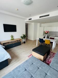 a living room with a bed and a dining room at Central Walk Apartment in Bratislava