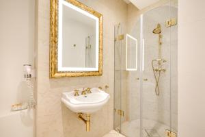 a bathroom with a sink and a shower at Hotel Wit Stwosz in Krakow +37 photos