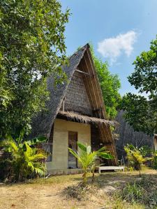 a small house with a thatched roof at Eco Lotus Kampot in Kampot