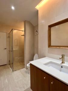 a bathroom with a sink and a toilet and a mirror at Sunset House Khao Yai in Pak Chong +14 photos