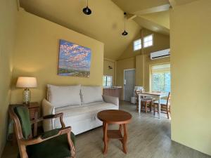 a living room with a couch and a table at Sunset House Khao Yai in Pak Chong