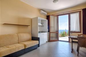 a living room with a couch and a table at Le Terrazze Appartamenti Vacanze in Sanremo