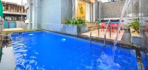 a large blue swimming pool with a water slide at Puranik sayama in Lonavala