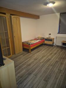 a room with a bed and a dresser in it at Monteurwohnung in Frielendorf