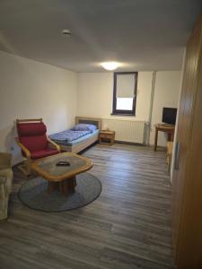 a living room with a couch and a coffee table at Monteurwohnung in Frielendorf