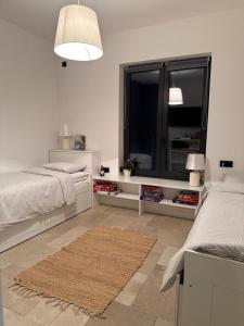a bedroom with two beds and a large window at Casa Elena in Banja Luka