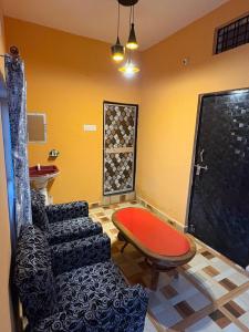 a living room with a couch and a table at The Prem Vatika Homestay Maihar in Maihar