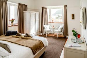 a bedroom with a bed with two teddy bears on it at The Muize in Muizenberg