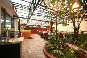 a dining room with tables and chairs and a cafeteria at Tibet Boutique Hotel Annex in Kathmandu