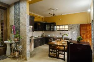 a kitchen with a table and a dining room at Simsar Villa Homestay in Bahāsi