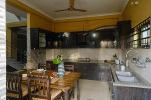 a kitchen with a wooden table and a sink at Simsar Villa Homestay in Bahāsi +50 photos