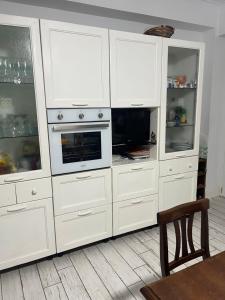 a large white cabinet with a microwave and a tv at Villa Rosa in Torre del Greco