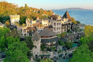 an aerial view of a castle on a hill at Hotel Tropicana Castle Sabang Mindoro in Sabang