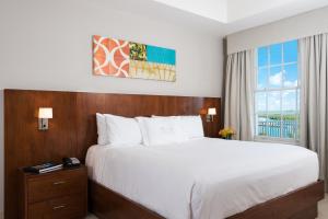 a bedroom with a large bed and a window at Blue Haven Resort- All Inclusive in Grace Bay