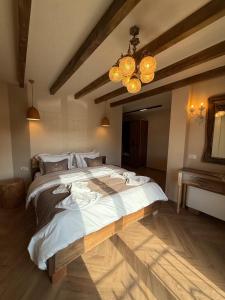 a bedroom with a large bed in a room at Hotel Restorant Unaza in Voskopojë +5 photos