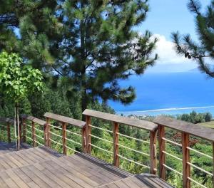 a wooden deck with a view of the ocean at Rava Lodge in Punaauia