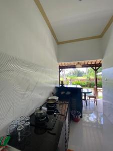 a kitchen with a stove with pots and pans at Shima House in Sukawati