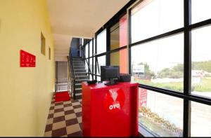 a room with a red object with a tv on top at SLP Residency in Mysore