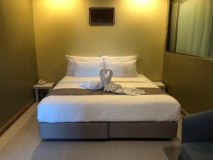 a hotel room with a bed with a towel on it at Work Den Chiangrai in Chiang Rai +16 photos
