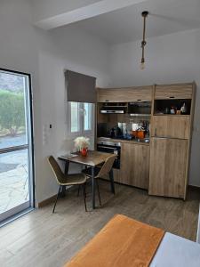 a kitchen with a table and a dining room at Cozy flat studio in Galaxidi