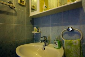 a bathroom with a sink and a mirror at Apartments Petrič in Koper +41 photos
