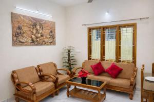a living room with two chairs and a table at Sri Apartment Homestay 2BHK Pondicherry A1 in Pondicherry