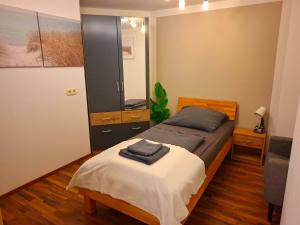 a bedroom with a bed and a large mirror at Gemütliches Apartment in Giengen an der Brenz
