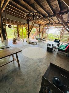 a large room with tables and benches in a building at Eco Lotus Kampot in Kampot