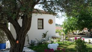 a white house with a sign on the side of it at Muyo House in Urla