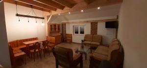 a living room with a table and a dining room at Apartmány v Bývalém mlýně in Rokytnice v Orlických Horách