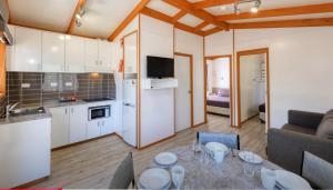 a kitchen and a living room with a table in a room at Macquarie Caravan Park in Warren