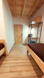 a room with a bed and a wooden floor at Apartmány v Bývalém mlýně in Rokytnice v Orlických Horách
