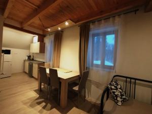 a kitchen and dining room with a table and chairs at Apartmány v Bývalém mlýně in Rokytnice v Orlických Horách +24 photos