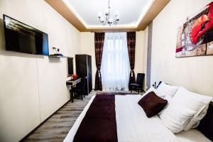 a hotel room with a white bed and a desk at Anna Central Studio in Sibiu
