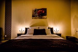 a bedroom with a large bed with two night stands at Anna Central Studio in Sibiu