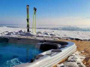 a snow raft sitting in the snow with skis at Villa Revere - luksus w sercu Podhala in Nowy Targ