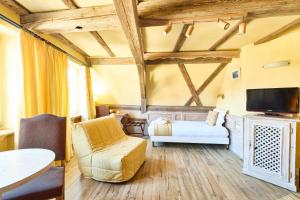 a hotel room with a bed and a tv at Logis Hotel Saint-Martin in Colmar