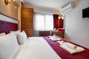 a hotel room with a bed with towels on it at Cihangir Palace Hotel in Istanbul +46 photos