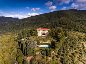 an aerial view of a house in a mountain at Villa Pitiana in Donnini