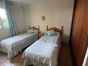 a room with two beds and a window at Can Chus Cala Anguila in Cala Mendia +14 photos