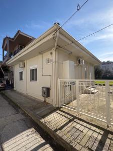 a house with a white fence in front of it at Tailor Garden House in Tríkala