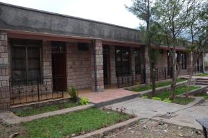an old brick building with windows and a courtyard at Selam Guest House in Lalibela