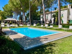 a swimming pool in a yard with chairs and trees at Aurora Holiday House in Vasto +30 photos