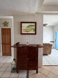a living room with a wooden table in a room at Villa Paradiso in Basseterre +25 photos